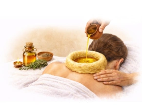 Ayurvedic Greeva Basti procedure showing warm medicated oil being poured into a dough ring on the cervical region of the neck.